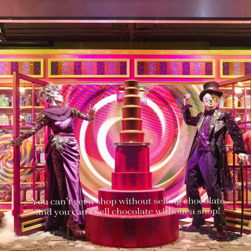 Mannequin dressed as Willy Wonka, next to a chocolate fountain. 